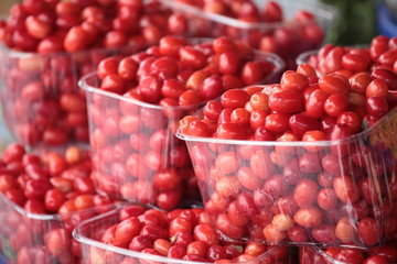 Kızılcık.Cornelian cherries (cranberries) on greengrocery.