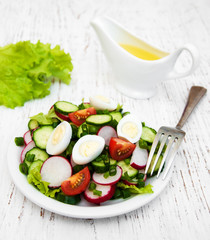 Spring salad with eggs, cucumbers and radish