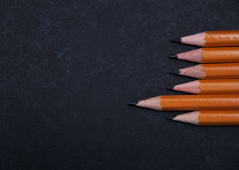 Pencils set on a blackboard