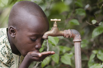 Water scarcity in the world symbol. African boy begging for water. In places like sub-Saharan Africa, time lost to gather water and suffering from water-borne diseases is limiting people's lives. - obrazy, fototapety, plakaty