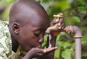 Little black boy asking begging for clean water. Its scarcity affects every continent. Around 1 billion people, live in areas of physical scarcity, and many more people approach this situation.