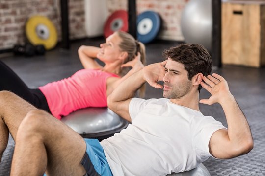  Fit couple doing abdominal crunches