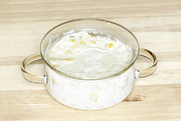 Rice milk porridge with pumpkin on a table in a glass pan
