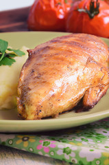 Grilled chicken fillet with mashed potatoes and grilled tomatoes. Rustic style.