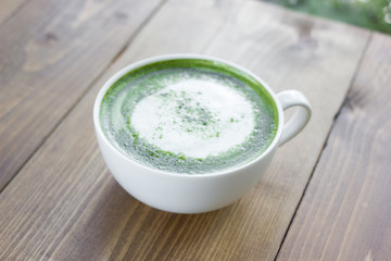 Matcha green tea latte beverage in glass.