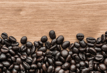 background of brown coffee beans on wood board
