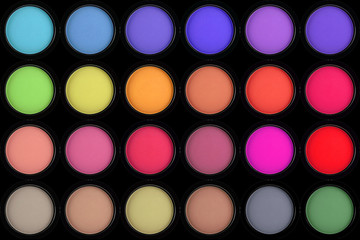 colorful eyeshadows in black boxes on black