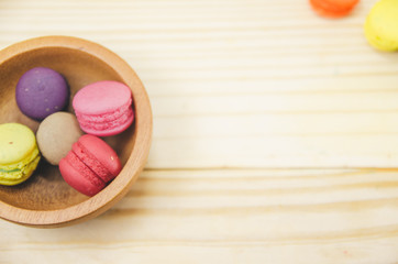 French macaroons on  wood background on filter color