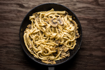 Homemade fettuccini pasta in cream sauce with mushrooms