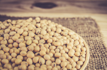 group of soy bean in wood plate on sack background