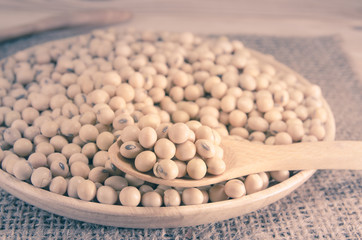 soybean on wooden board and sack