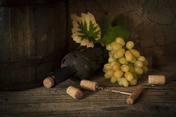 still life with red wine and barrel on old wood