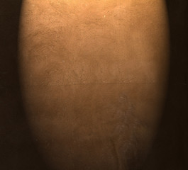 Brown painted  plaster pattern  background with spotlight and  place for your design or text