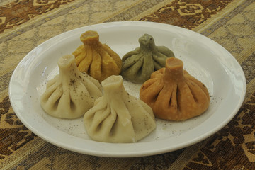 Multicolored Georgian Khinkali in white plate