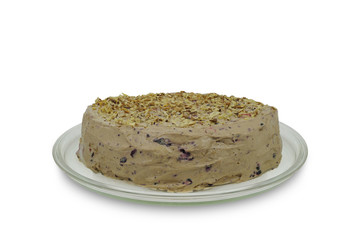 Homemade cake  with nuts and bilberries on glass plate  isolated on white