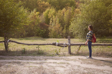 The girl with the backpack travels alone.