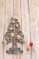 Decorative christmas tree with ball on wooden background