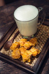 Hot milk in a glass on  wooden Backgrounds