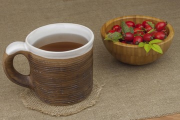 A flu epidemic. Traditional home treatment for colds and flu. Rosehip tea, honey and citrus. Hot tea with honey and lemon on a tabletop. Home Pharmacy. Proven treatment of diseases.
