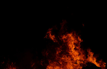 Fototapeta na wymiar Beautiful abstract flame of fire on the black background