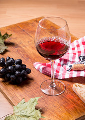 Red wine against wooden background