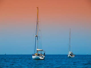 Two anchoring yachts