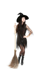 Young brunette witch with broom isolated on a white