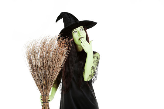 Young brunette witch with broom on a white background