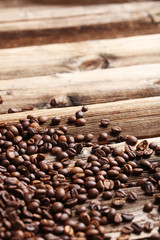 Roasted coffee beans on a brown wooden background