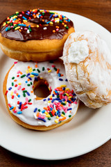 Stacked donuts on brown table. Shallow depth of field 