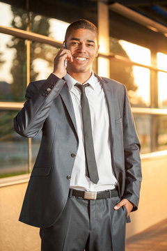 Successful businessman talking on mobile and smiling