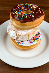 Stacked donuts on brown table. Shallow depth of field 