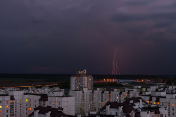 Obraz premium lightning in the night sky over the city houses