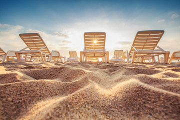 Beach chairs on the exotic tropical beach, sunrise shot