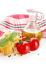 Photo of tagliatelle pasta with cherry tomatoes at the top on white