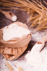 Flour in  bag and wooden spoon
