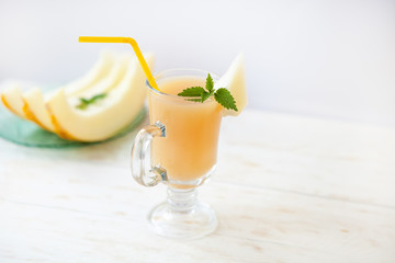 Melon smoothies with mint leaf, cut slices of melon