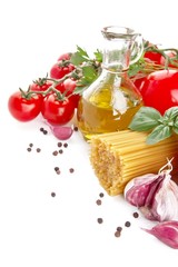 Left side shot of pasta with tomatoes,basil,oil,garlic on white