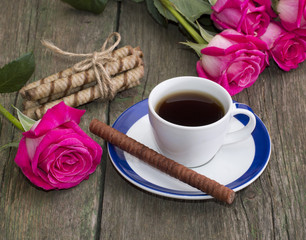 coffee still life, cookies in the form of sticks and a rose on e