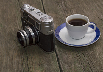 still life the old camera and coffee, on a table