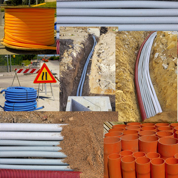 roll of corrugated conduit and bundle of red pvc pipes for underground pipelines sewer