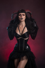 Sexy female demon in fetish costume