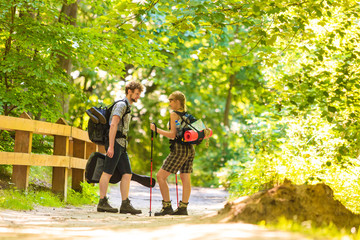 Fototapeta premium couple backpacker hiking in forest pathway