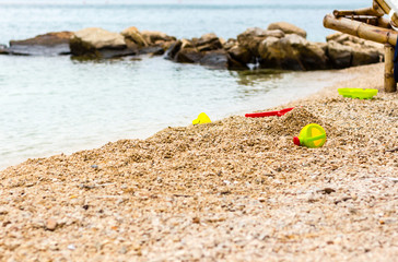 Children's beach toys - buckets, spade and shovel on sand on a sunny day