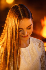 Woman relaxing at fireplace. Winter home.