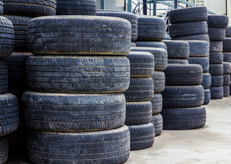 Fototapeta na wymiar Old used tires stacked with high piles