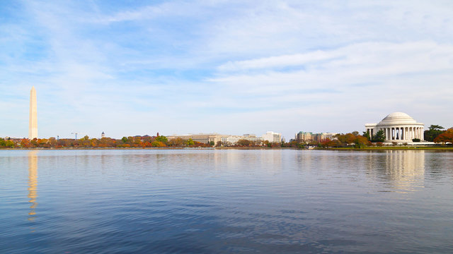 Washington Monument and Thomas Jefferson Memorial in the Fall. Panoramic view of the Tidal Basin with major national capital attractions surrounded by the colorful tree foliage in the Fall.