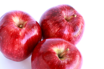 Fresh three red apples isolated on white background.
