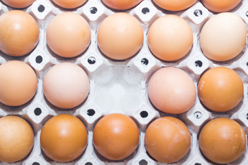 Cardboard egg box and many eggs
