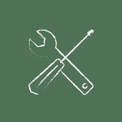 Screwdriver and wrench tools icon drawn in chalk.